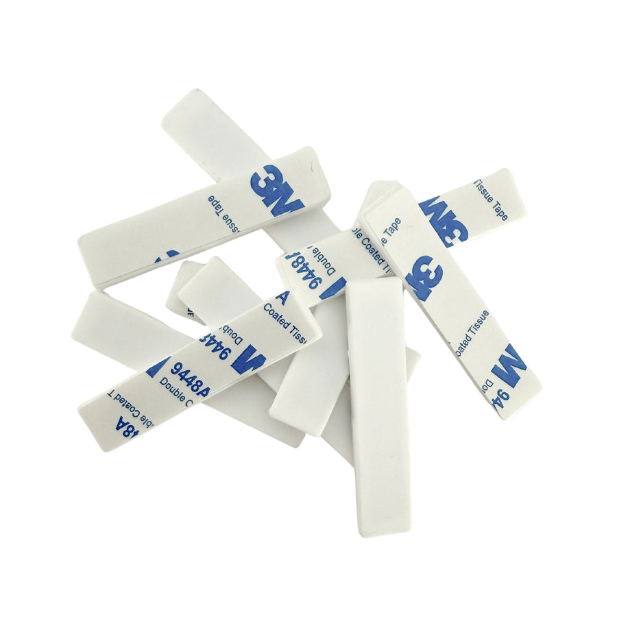 White adhesive strips with blue '3M' branding on a white background